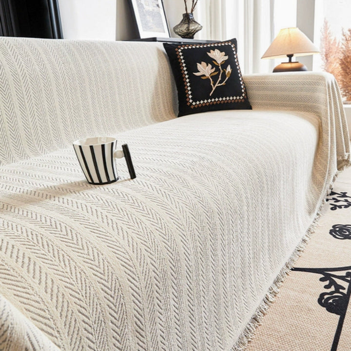niki-herringbone-knit-sofa-blanket-with-tassels-24aeb51c_8b91e712-6a00-4f57-8e55-0c3d7cb1a8dc